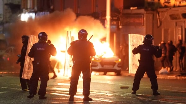 A car was on fire amid the ongoing disorder in Dublin city centre after three
young children and a woman were injured in a stabbing outside a school