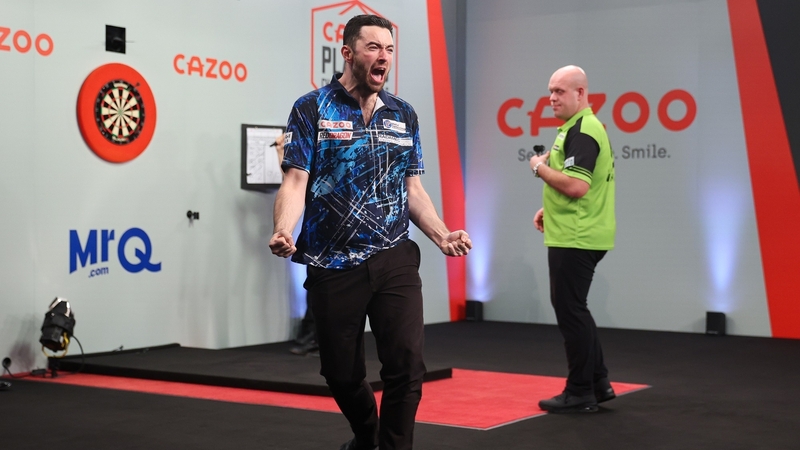 Luke Humphries (L) celebrates during the final against Michael van Gerwen