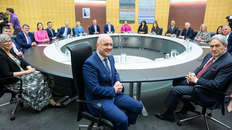 New Zealand Prime Minister Christopher Luxon (C) made the announcement on his first day in office