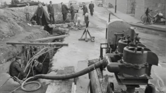Dublin Corporation workers repair a leak in a pipe under the River Liffey, 1964.