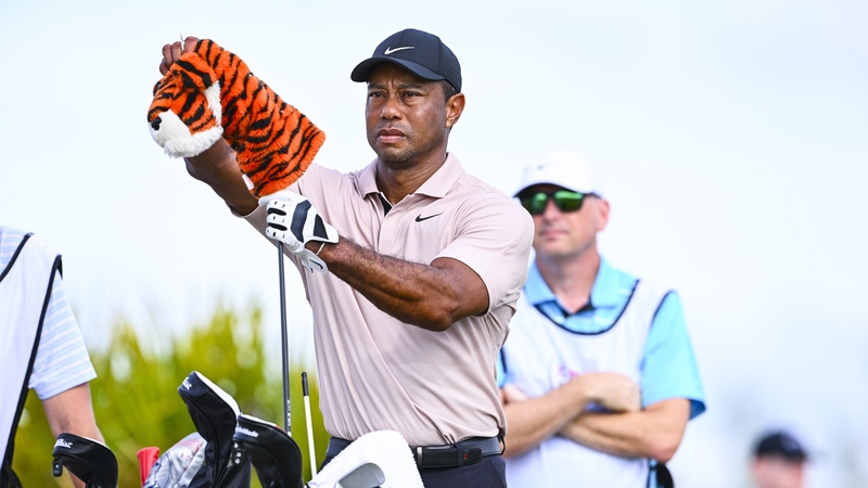 Tiger Woods removes his Frank headcover from his driver on the seventh hole tee during the first round