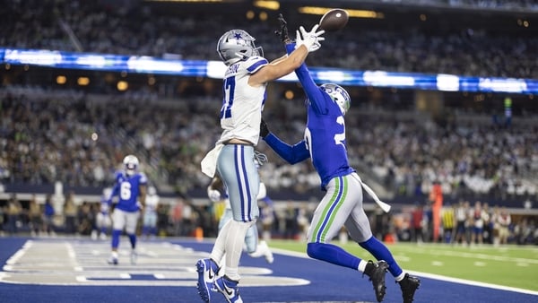 Riq Woolen (right) of the Seattle Seahawks attempts to defend a pass intended for Jake Ferguson of the Dallas Cowboys