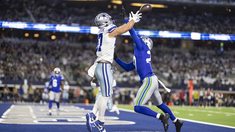 Riq Woolen (right) of the Seattle Seahawks attempts to defend a pass intended for Jake Ferguson of the Dallas Cowboys