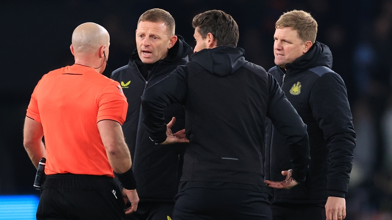 Eddie Howe (R) and his coaching staff confront referee Szymon Marciniak after Newcastle's controversial draw at Paris Saint-Germain