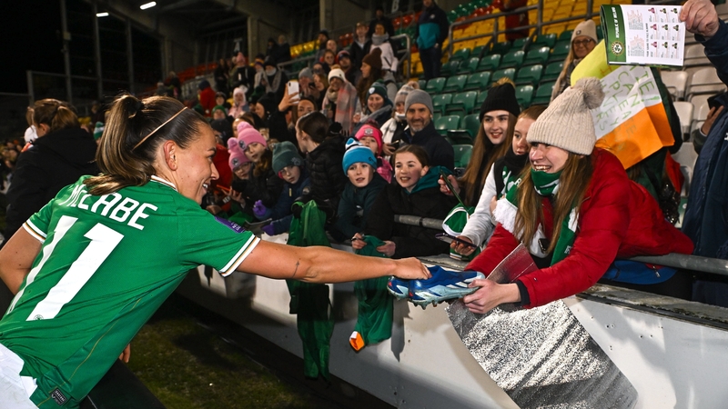 Katie McCabe passes her boots to a young supporter after Ireland's win against Hungary at Tallaght Stadium