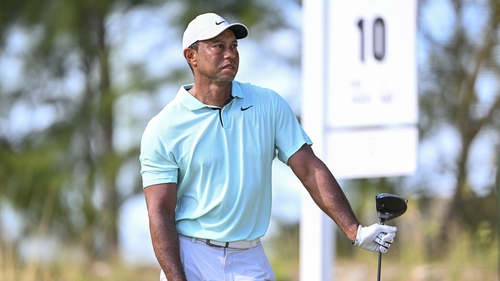 Tiger Woods watches his tee shot at the 10th tee