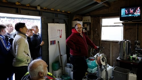 The groundsman and fans watch the draw before the second round match between Aldershot and Stockport