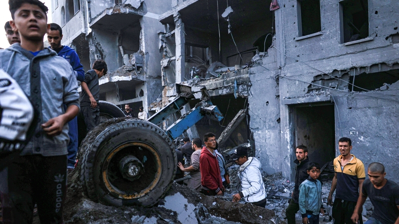 Palestinians check the damage caused by an Israeli attack in Rafah in southern Gaza