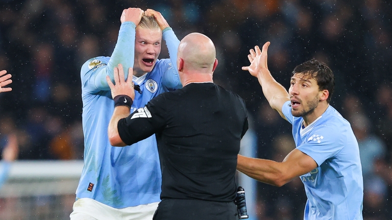 Erling Haaland (L) struggles to contain his frustrations after referee Simon Hooper late decision