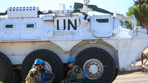 Members of the United Nations Interim Forces in Lebanon (UNIFIL) rest next to an armed vehicle near the southern Lebanese village of Markaba