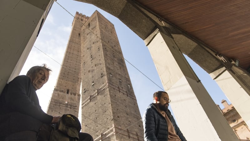 The 12th century Garisenda tower standing beside the taller Asinelli tower