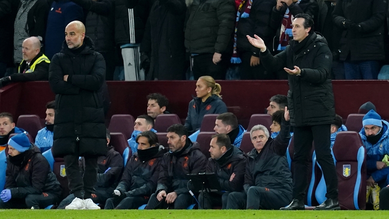 Manchester City manager Pep Guardiola (L) and Aston Villa boss Unai Emery on the touchline