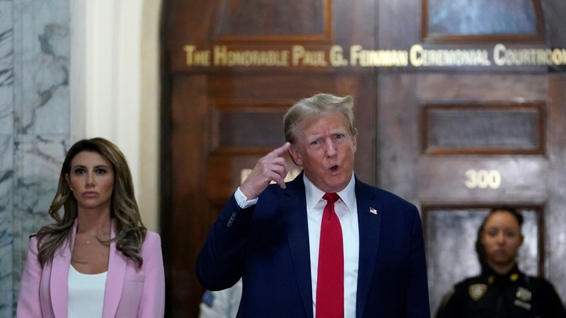 Donald Trump speaking to members of the media as he arrives at the New York State Supreme Court