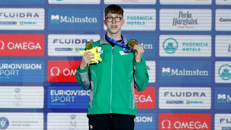 Daniel Wiffen receives his gold medal after winning the men's 1500m freestyle