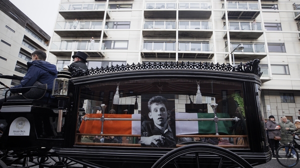 The funeral procession of Shane MacGowan makes its way along Pearse Street in Dublin
