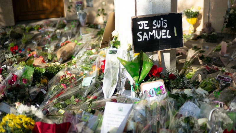 Tributes left outside the school where Samuel Paty taught in the aftermath of his murder