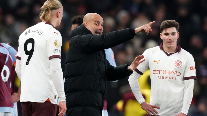 Manchester City manager Pep Guardiola speaks with Erling Haaland and Julian Alvarez during the loss to Aston Villa