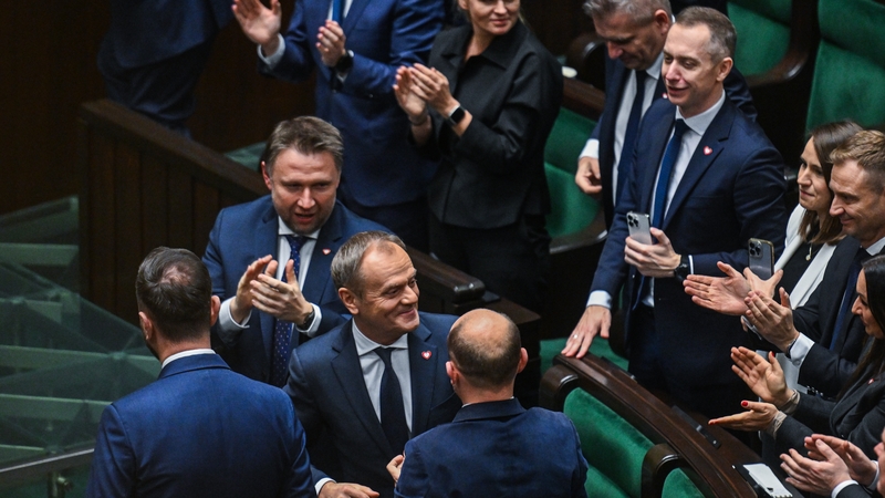 Donald Tusk (centre) is congratulated by party members after receiving a majority of votes to become prime minister