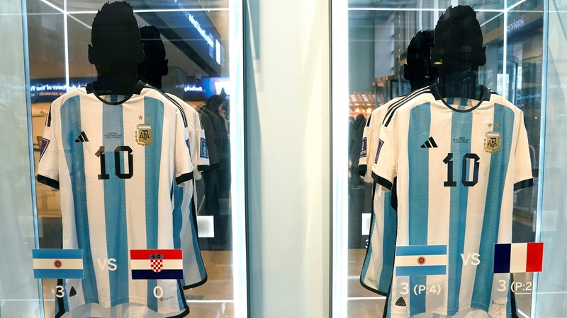 The shirt worn in the 2022 semi-final match between Argentina and Croatia (L), and the one worn in the final against France (R), are displayed during a Sotheby's auction preview
