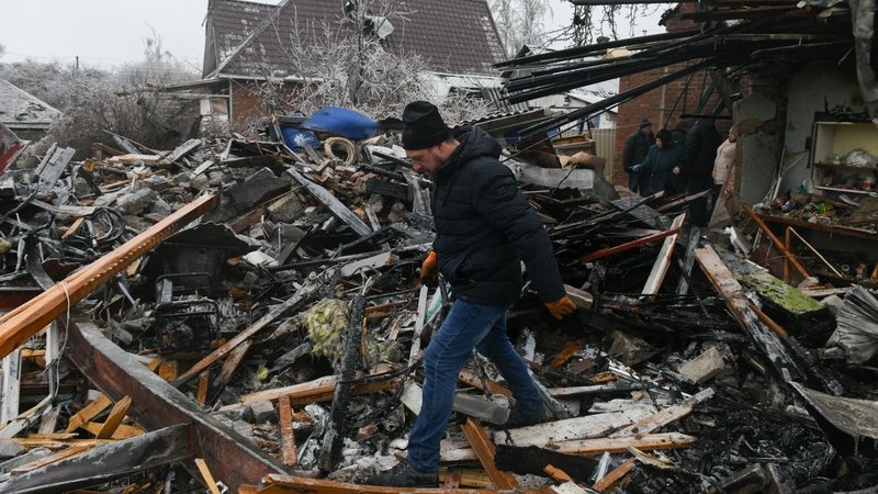 A man walks through rubble in the aftermath of recent shelling in Yasynuvata in Ukraine today
