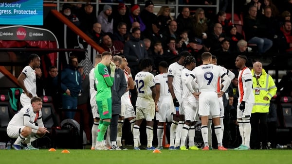 Luton players on pitch after their captain Tom Lockyer collapsed at Bournemouth