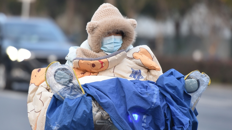 Motorcyclists in Fuyang, Anhui province wear extra layers as they drive through the city