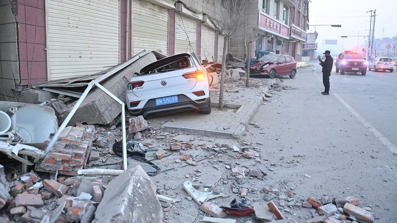 Rubble covers cars on a road in Gansu province in China