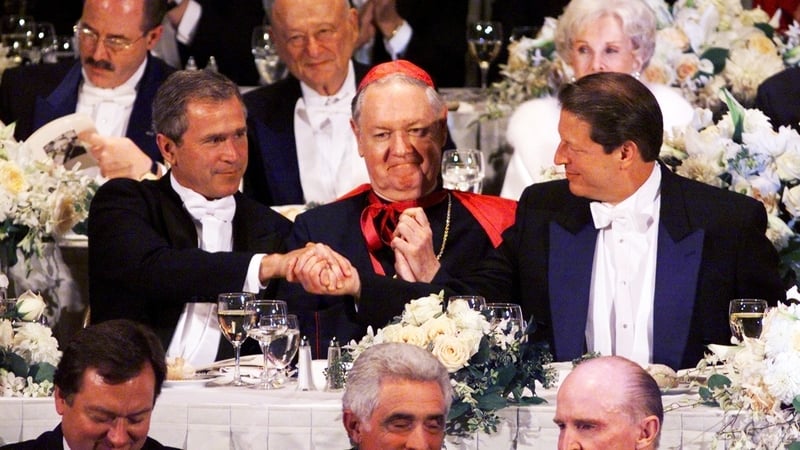 Presidential candidates George W Bush and 'wooden' Al Gore either side of Archbishop Edward Egan, October, 2000