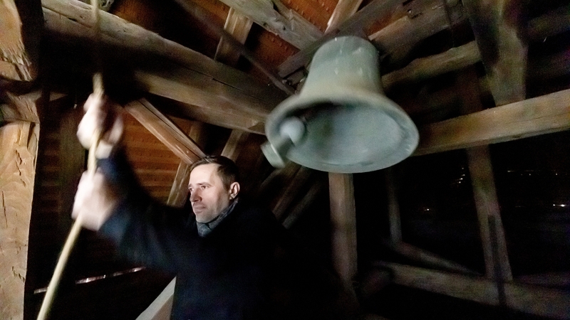 Vasek Pesek rings the bell at noon in a small church in Nejdek, Czech Republic, commemorating the victims of the Charles University's shooting