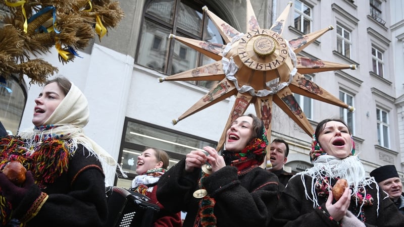 People sing carols as they take part in Christmas eve celebrations in Lviv, Ukraine