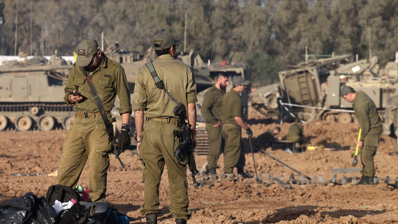 Israeli soldiers gather around tanks near the border with the Gaza Strip in southern Israel