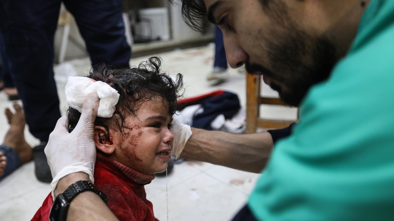 A young child is treated for injuries following an Israeli strike on Khan Yunis