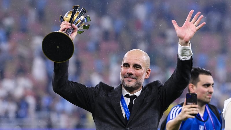 Pep Guardiola holds aloft the Club World Cup trophy