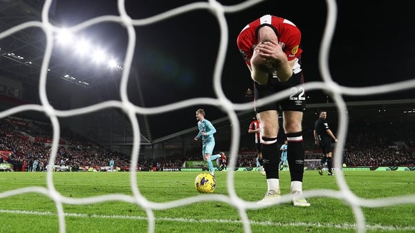 Nathan Collins holds his head in his hands after Ricner Bellegarde scores Wolverhampton Wanderers' fourth goal