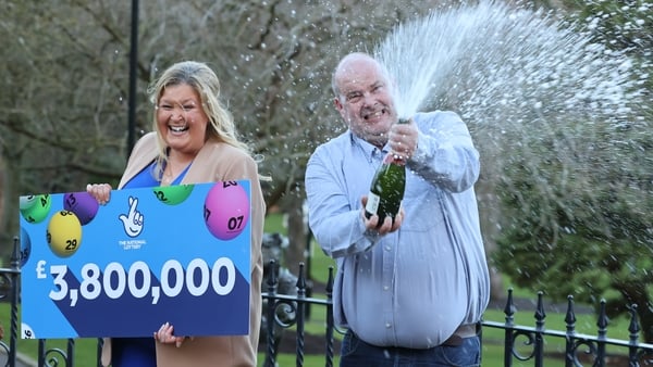 Jonny Johnston and his partner Christina Williams celebrate after winning £3,800,000 on the lotto draw