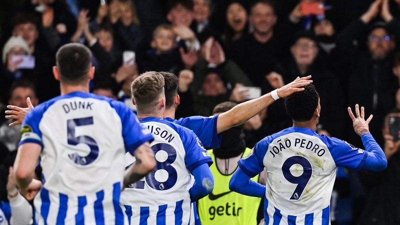 Brighton's Joao Pedro (R) celebrates after scoring his team's fourth against Spurs