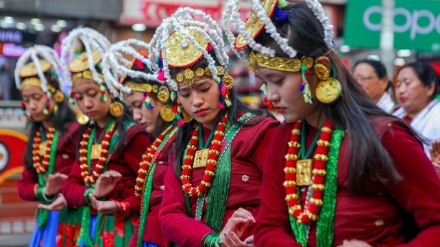 Nepalese women from the Gurung community dance in traditional attire at a parade to mark the New Year