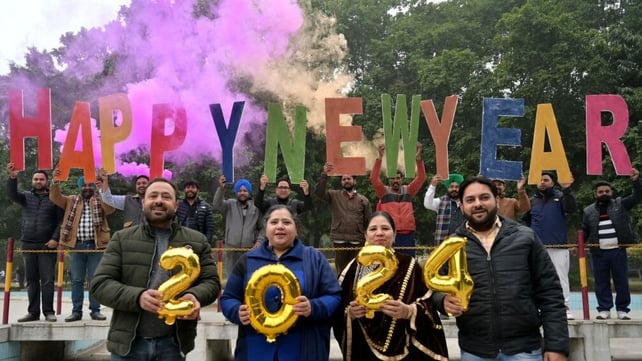 People holding 'Happy New Year' letters in Amritsar, India
