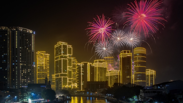 Fireworks explode over skyscrapers during New Year's celebrations in Manila, Philippines