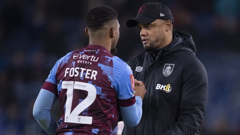 Burnley manager Vincent Kompany talks to Lyle Foster