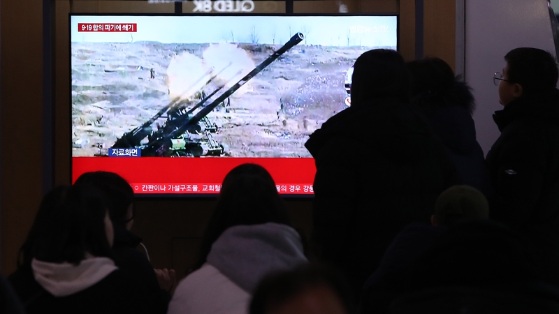 People in Seoul watch a news broadcast with file footage of a North Korean missile test