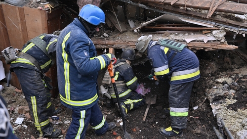 Rescuers operate on a building in Zmiiv following Russian strikes on the Kharkiv region