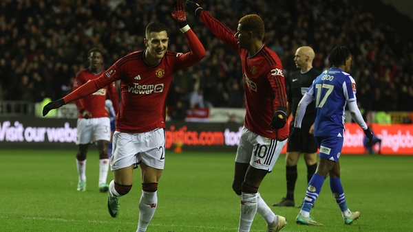 Diogo Dalot, left, celebrates with team-mate Marcus Rashford after scoring against Wigan Athletic