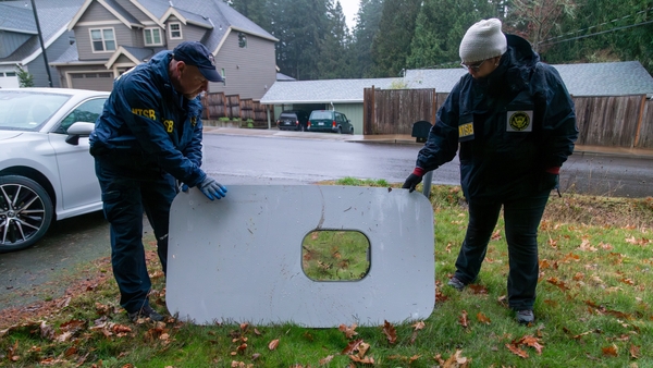 US National Transport Safety Board investigators with the recovered door plug from Alaska Airlines Flight 1282