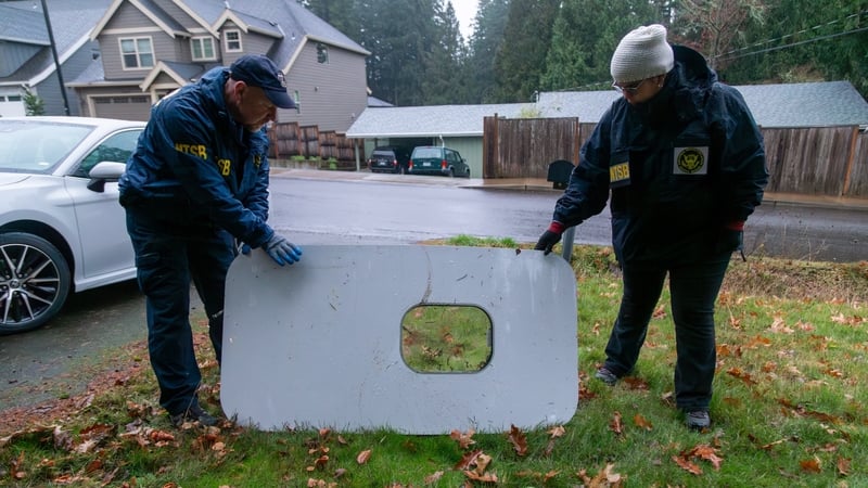 US National Transport Safety Board investigators with the recovered door plug from Alaska Airlines Flight 1282