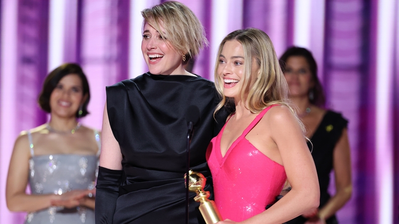 (L-R) Barbie director Greta Gerwig and star Margot Robbie accept the award for Cinematic and Box Office Achievement for Barbie at the Golden Globe Awards on Sunday night