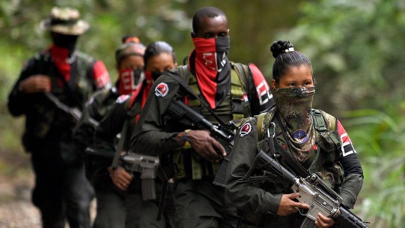 Rebels of the National Liberation Army (ELN) patrol near the Baudo river in Choco province, Colombia on 26 October 2023