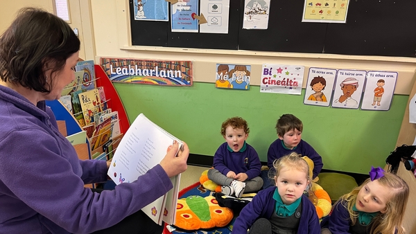 Gearóidín Munroe reads to her students at Naíscoil na Seolta