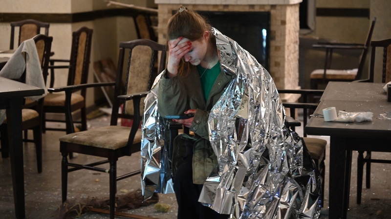 A hotel worker in a blanket following a Russian missile attack on a hotel in Kharkiv, northeastern Ukraine