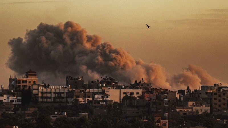 Smoke rises over buildings following Israeli attacks on al-Maghazi Refugee Camp in Deir al-Balah, Gaza